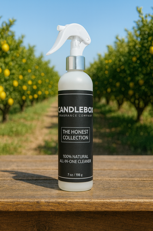 Honest All-in-One Cleaner spray bottle from The Honest Collection by Candlebox on wooden surface outdoors