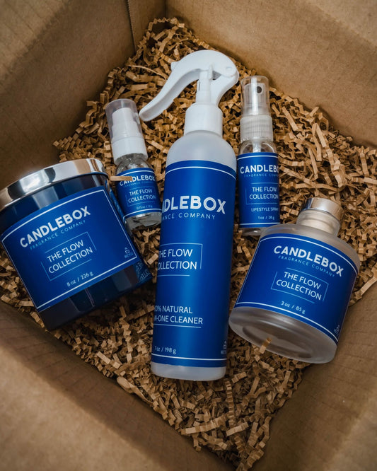 FLOW Candlebox natural candle and home care products set in packaging with blue labels