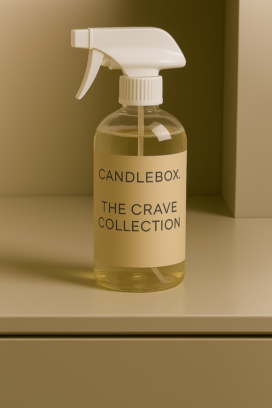 Clear spray bottle of Crave All-in-One Cleaner from Candlebox The Crave Collection on beige surface